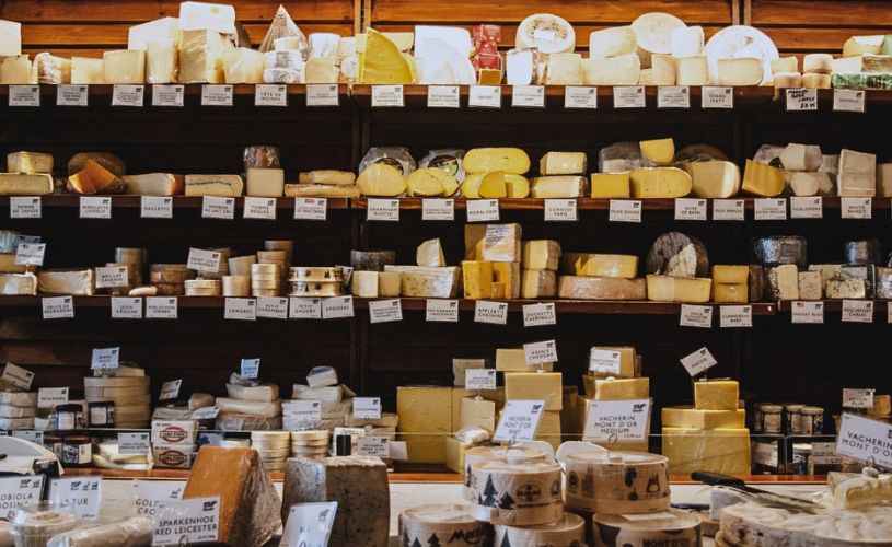 Shelves of cheese in shop